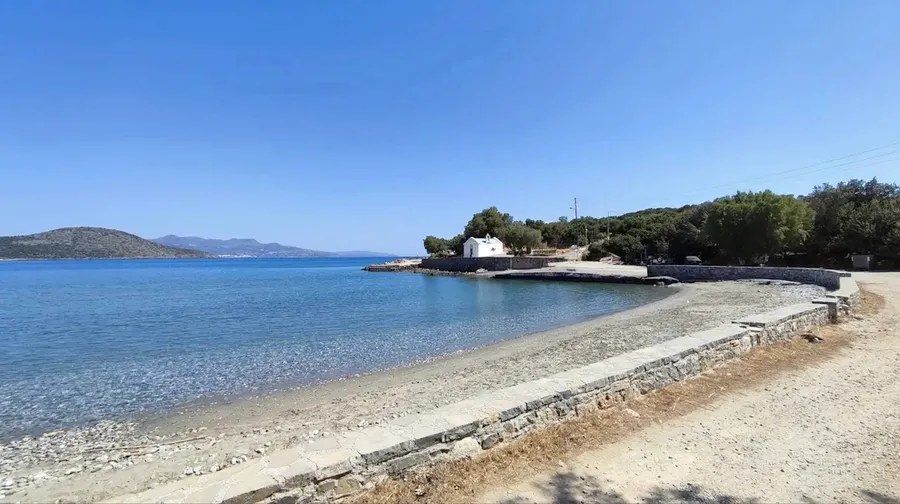 Small quiet sandy beach with calm water at Agiou Panteleimonos Beach