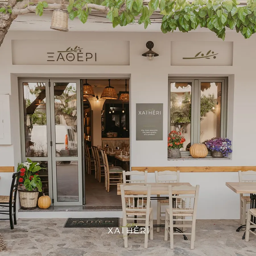 Outdoor dining space surrounded by greenery at Xatheri